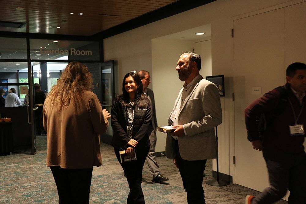 Hallway networking at the NJHA Medicare and Managed Care Summit — Genzeon Platforms team in conversation with hospital and CMS leaders between sessions